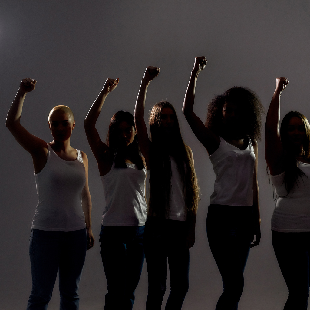 Untitled design (39) silhouette of women with fists in the air