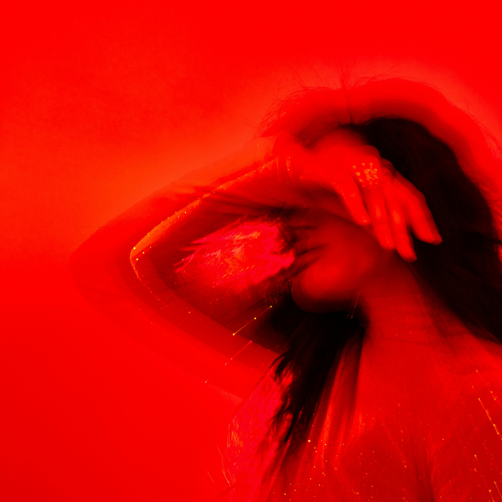 red filter overlaying a photo of a woman in distress maybe having a hot flash