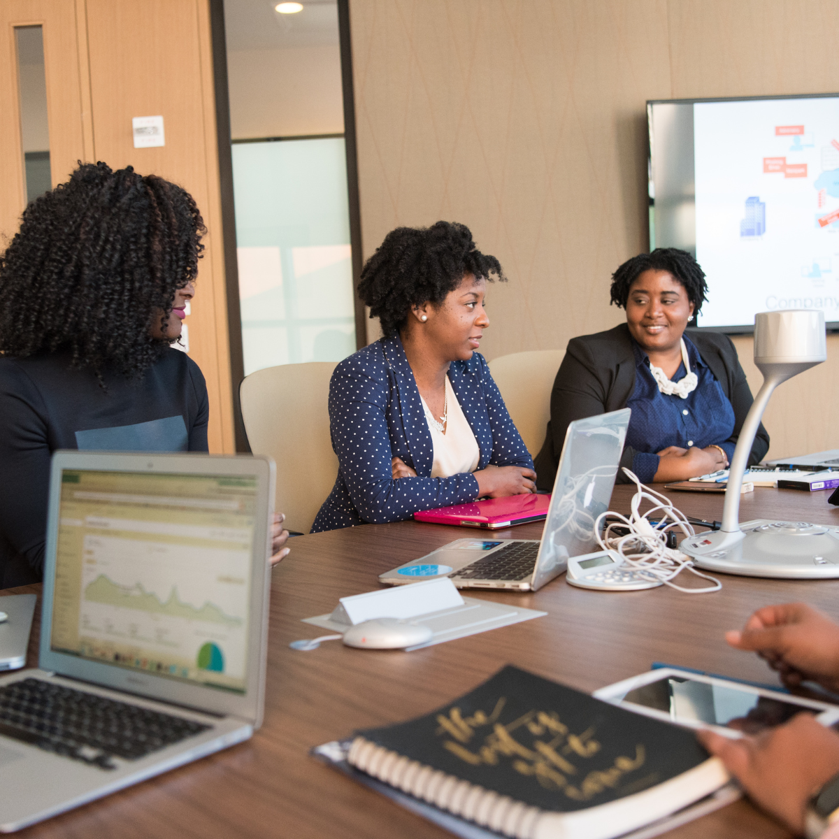 Untitled design (100) midlife women sitting around a conference table